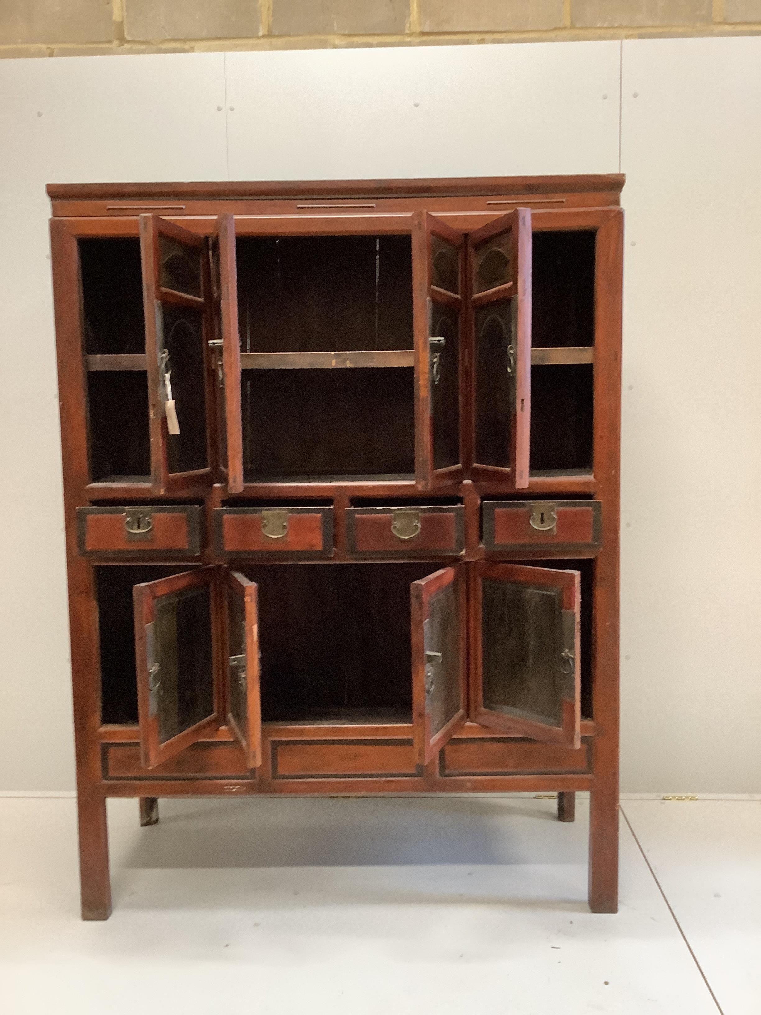 A Chinese lacquered pine side cabinet, width 134cm, depth 55cm, height 180cm